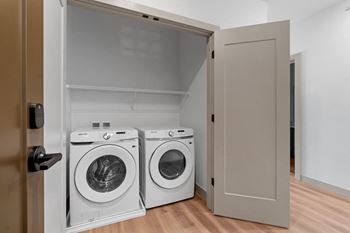 Washer and dryer in a laundry room with a closet